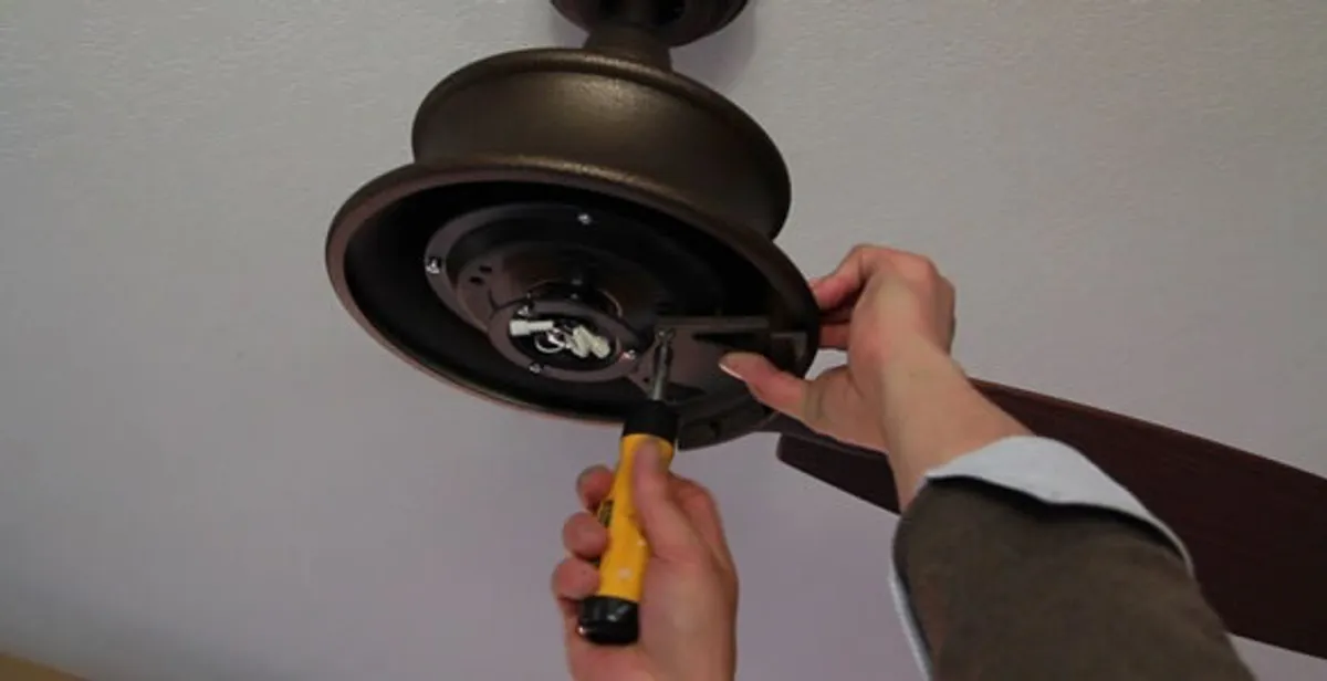 Electrician installing ceiling fan mounting bracket and fixture in Escondido, CA