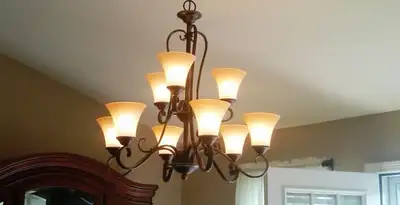 Classic ceiling chandelier installation with warm lighting in Escondido, CA