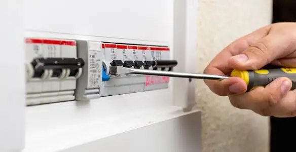 electrical panel upgrade service showing technician adjusting circuit breakers during system upgrade in Escondido, CA