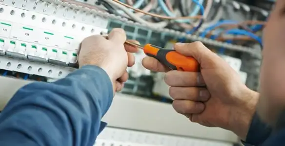 electrical service showing licensed electrician performing electrical panel maintenance and adjustments in Escondido, CA