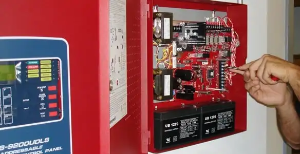 fire alarm installation service showing technician configuring fire alarm control panel in Escondido, CA