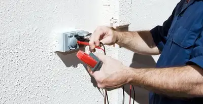 Electrician performing home electrical outlet and wiring inspection in Escondido, CA