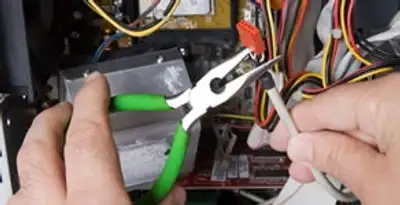 Licensed electrical contractor performing electrical repair with tools in Lakeside, CA