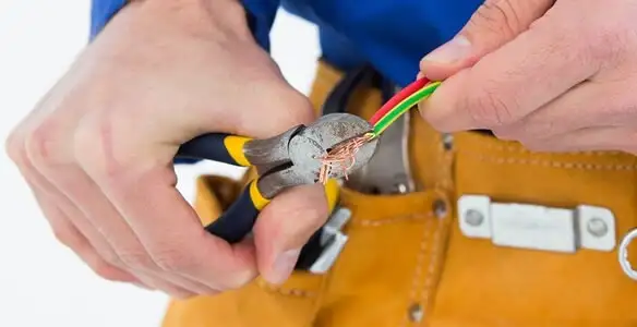 licensed electrician securing electrical wiring with professional tools during service work in Escondido, CA