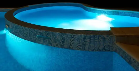 pool light installation and repair services highlighting illuminated pool interior lighting in Escondido, CA