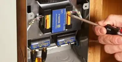 Whole home surge protection device being installed by a licensed electrician to protect electrical systems in Escondido, CA